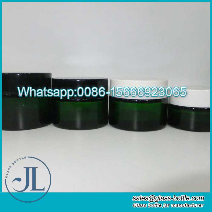 green coloured glass cosmetic jars with black cap